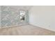 Bedroom with statement wallpaper, carpeted floors, and a bright window at 4171 Towncastle Ln, Buford, GA 30518