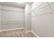 Walk-in closet with carpet flooring and wire shelving ready for organization at 4171 Towncastle Ln, Buford, GA 30518