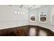 Bright dining room with hardwood floors, detailed trim, and modern lighting fixtures at 4171 Towncastle Ln, Buford, GA 30518