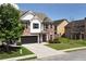 Charming brick and white two-story home with a well-maintained lawn, black shutters, and a two-car garage at 4171 Towncastle Ln, Buford, GA 30518