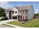 Two-story home with a manicured lawn, a two car garage, and beautiful landscaping at 4171 Towncastle Ln, Buford, GA 30518