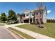 Two-story home with brick and white accents, a two-car garage, and a well-maintained lawn at 4171 Towncastle Ln, Buford, GA 30518
