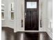 Elegant foyer featuring dark hardwood floors, white trim, and natural light at 4171 Towncastle Ln, Buford, GA 30518