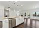 Modern kitchen featuring stainless steel appliances and a granite countertop island at 4171 Towncastle Ln, Buford, GA 30518