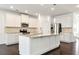 Well-lit kitchen featuring a center island, white cabinets, granite countertops, and stainless steel appliances at 4171 Towncastle Ln, Buford, GA 30518
