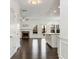 Open-concept living area with a fireplace and an island with dark hardwood floors at 4171 Towncastle Ln, Buford, GA 30518