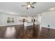 Open-concept living room with dark hardwood floors connecting to a modern, white kitchen at 4171 Towncastle Ln, Buford, GA 30518