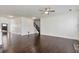 Open concept room featuring hardwood floors, staircase, and access to other rooms at 4171 Towncastle Ln, Buford, GA 30518
