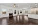 Living room with dark hardwood floors, marble fireplace, and open access to kitchen at 4171 Towncastle Ln, Buford, GA 30518