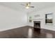 Spacious living room featuring a marble fireplace, ceiling fan, and dark hardwood floors at 4171 Towncastle Ln, Buford, GA 30518