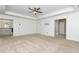 Spacious main bedroom featuring plush carpet, ceiling fan, and access to an attached sitting area at 4171 Towncastle Ln, Buford, GA 30518
