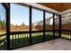 Relaxing screened porch with black frames provides an outdoor living space and a view of the backyard at 4171 Towncastle Ln, Buford, GA 30518
