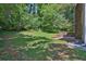 View of the backyard featuring a grassy area with lots of trees at 752 Roxboro Trce, Lawrenceville, GA 30044