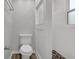 Bathroom with decorative flooring, white tile shower, and a toilet at 752 Roxboro Trce, Lawrenceville, GA 30044