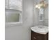 Bathroom with dark vanity, undermount sink, and Hollywood-style light fixture at 752 Roxboro Trce, Lawrenceville, GA 30044
