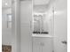 Bathroom with black and white backsplash, storage cabinet, and vanity at 752 Roxboro Trce, Lawrenceville, GA 30044