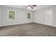 Bedroom with carpet, ceiling fan, and bright natural light from two windows at 752 Roxboro Trce, Lawrenceville, GA 30044