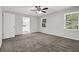 Bedroom with two windows, ceiling fan, carpet, and white doors and trim at 752 Roxboro Trce, Lawrenceville, GA 30044