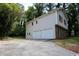 Rear view of a two story home featuring an attached garage and long driveway at 752 Roxboro Trce, Lawrenceville, GA 30044