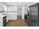 Bright kitchen with white cabinets, stainless steel appliances, and wood flooring at 752 Roxboro Trce, Lawrenceville, GA 30044