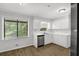 Bright kitchen with white cabinets, stainless steel dishwasher and a large window at 752 Roxboro Trce, Lawrenceville, GA 30044
