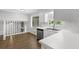 Open kitchen with white cabinets, stainless steel appliances and adjacent dining area at 752 Roxboro Trce, Lawrenceville, GA 30044