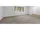 Spacious living room with big window and carpet flooring at 752 Roxboro Trce, Lawrenceville, GA 30044