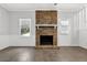 Cozy living room with brick fireplace, white wainscoting, and a bright window at 752 Roxboro Trce, Lawrenceville, GA 30044