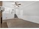 Living room with fireplace, tile floor, ceiling fan, and stairs to upper level at 752 Roxboro Trce, Lawrenceville, GA 30044