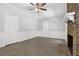 Cozy living room with a brick fireplace, tile flooring, ceiling fan and white trim at 752 Roxboro Trce, Lawrenceville, GA 30044
