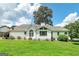 A well-manicured backyard featuring lush green grass and a charming white home exterior at 98 Country Acres Ct, Mcdonough, GA 30253