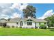 Bright backyard featuring a well-maintained lawn, mature landscaping, and an enclosed porch area at 98 Country Acres Ct, Mcdonough, GA 30253