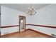 Traditional dining room featuring hardwood floors and a classic chandelier at 98 Country Acres Ct, Mcdonough, GA 30253