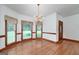 Dining room with hardwood floors, large windows, and classic chandelier at 98 Country Acres Ct, Mcdonough, GA 30253