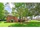 Charming brick home featuring lush green lawn and mature trees offering great shade and curb appeal at 98 Country Acres Ct, Mcdonough, GA 30253
