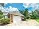 Exterior view showing a two-car garage and spacious driveway at 98 Country Acres Ct, Mcdonough, GA 30253