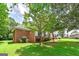 Well-maintained brick home featuring lush landscaping and mature trees at 98 Country Acres Ct, Mcdonough, GA 30253