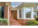 Charming brick home with a welcoming front entrance and landscaped garden at 98 Country Acres Ct, Mcdonough, GA 30253