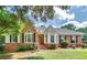 Charming brick home with manicured lawn, mature trees and traditional architectural details at 98 Country Acres Ct, Mcdonough, GA 30253