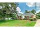 Traditional brick home with a beautifully landscaped front yard, mature trees, and well-maintained lawn at 98 Country Acres Ct, Mcdonough, GA 30253