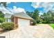 Spacious two-car garage with a concrete driveway and mature landscaping at 98 Country Acres Ct, Mcdonough, GA 30253