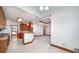 Open kitchen with wood cabinets, peninsula, and a view into the living area at 98 Country Acres Ct, Mcdonough, GA 30253