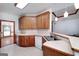 Eat-in kitchen with bar, pendant lights, neutral countertops and wooden cabinets at 98 Country Acres Ct, Mcdonough, GA 30253