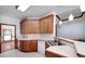 Kitchen boasts wood cabinets, white countertops, and stainless steel sink at 98 Country Acres Ct, Mcdonough, GA 30253
