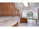 Bright kitchen featuring wood cabinets, skylight, and open view to the dining area at 98 Country Acres Ct, Mcdonough, GA 30253