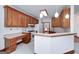 Bright kitchen with tiled floors, wooden cabinets, white appliances, and a breakfast bar at 98 Country Acres Ct, Mcdonough, GA 30253