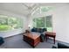 Bright sunroom with large windows, vaulted ceiling, and comfortable seating at 98 Country Acres Ct, Mcdonough, GA 30253