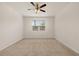 Spacious bedroom featuring neutral carpet, a ceiling fan, and a bright window at 1626 Palladian Way, Lithonia, GA 30058