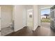 Open foyer with view to bathroom and bedroom, showcasing attractive hardwood floors and natural light at 1626 Palladian Way, Lithonia, GA 30058