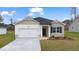 Charming single-story home featuring a manicured lawn, attached garage, and inviting front entrance at 1626 Palladian Way, Lithonia, GA 30058